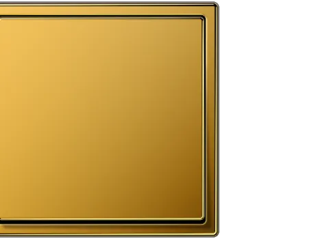 Ein quadratischer Lichtschalter der Serie LS-990 von JUNG in glänzendem Goldton, mit einem schlichten, modernen Design und leicht abgerundeten Kanten.